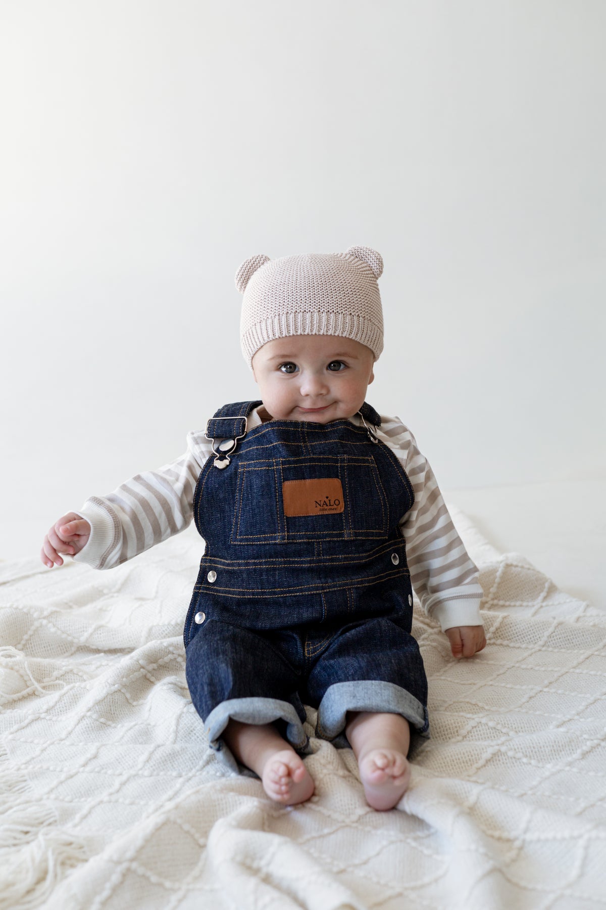 Baby wearing a denim dungaree